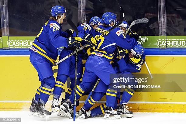 Team Sweden celebrates Alexander Nylander's opening goal during the 2016 IIHF World Junior U20 Ice Hockey Championships tournament match Canada vs...