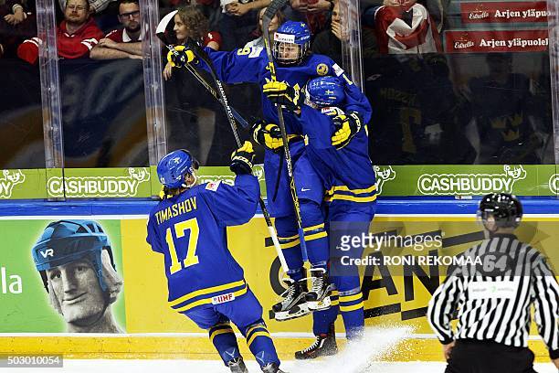 Dmytro Timashov, goal scorer Alexander Nylander and Marcus Pettersson of team Sweden celebrate opening goal during the 2016 IIHF World Junior U20 Ice...