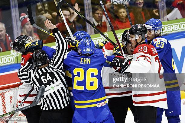 Players of team Sweden and team Canada scuffle during the 2016 IIHF World Junior U20 Ice Hockey Championships tournament match Canada vs Sweden in...