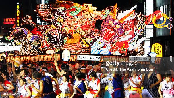People march on with illuminated 'Nebuta' floats during the Aomori Nebuta Festival on August 2, 2006 in Aomori, Japan.