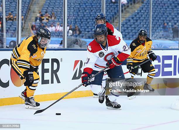 Julie Chu of the Les Canadiennes carries the puck against the Boston Pride during the Outdoor Womens Classic at Gillette Stadium on December 31, 2015...