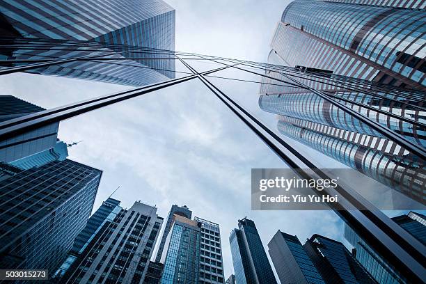 refection of buildings on a skyscraper facade - zona financiera fotografías e imágenes de stock