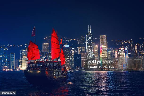 chinese junkboat sailing across victoria harbour - junk ship stock pictures, royalty-free photos & images