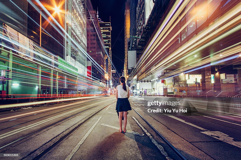 Young woman is lost in metropolitan city at night