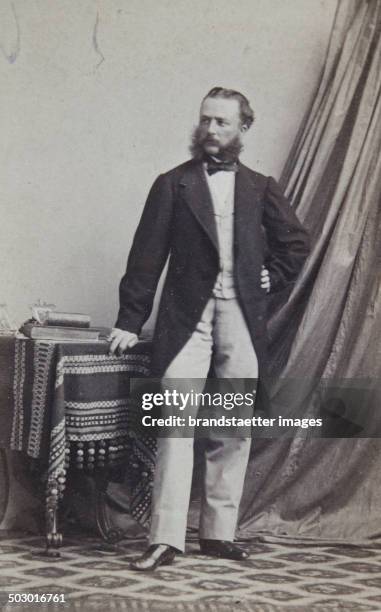 Men with upper lip and sideburns in a dark frock coat. With a bright vest and pants. Full figure. About 1865. Photograph by Neubauer / Kissingen -...