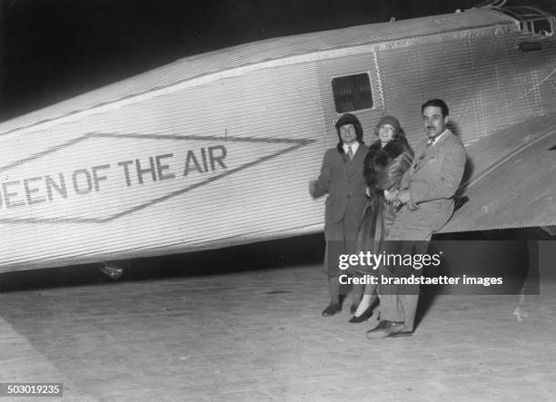 The pilots Charles A. Levine and Mabel Boll and Bert Acosta at the Le Bourget airport with her Junker aircraft The Queen of the Air. 1928. Photograph.