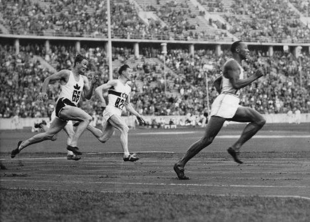 The American runner Jesse Owens running in the 200-meter sprint a new Olympic record. Berlin. 4th August 1936. Photograph.