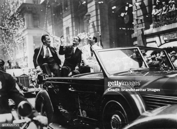 The flight pilot Howard Hughes is congratulated after his record flight around the world in New York. July 1938. Photograph.