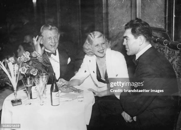 The German boxer Max Schmeling and Hans Breitensträter with singer Lee Parry at the Palais de Danse at a charity event. 16th December 1932....