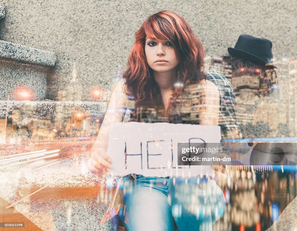 Unhappy teenager showing a paper with help wanted sign