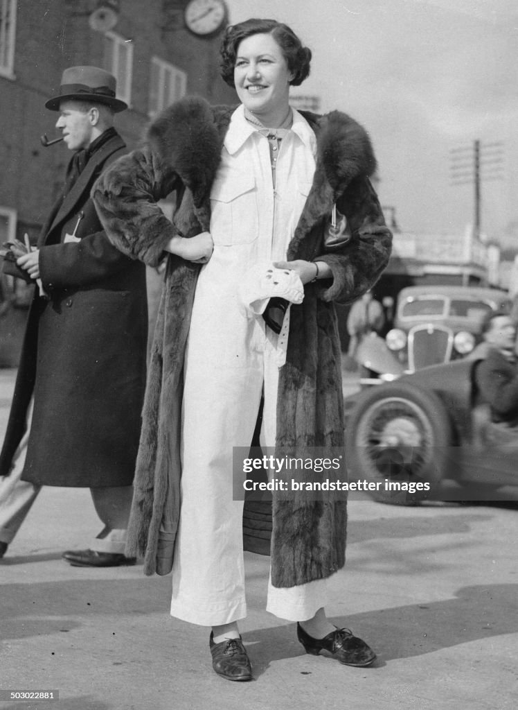 The Racer Roy Eccles In A Fur Coat Over The Racing Clothes. Brooklands. 14Th March 1936. Photograph.