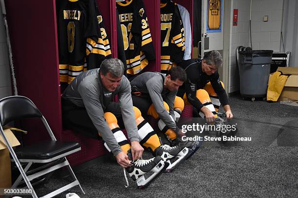 Cam Neely, Don Sweeney and Ray Bourque of the Boston Bruins in the locker room before the game against the Montreal Canadiens on December 31, 2015...