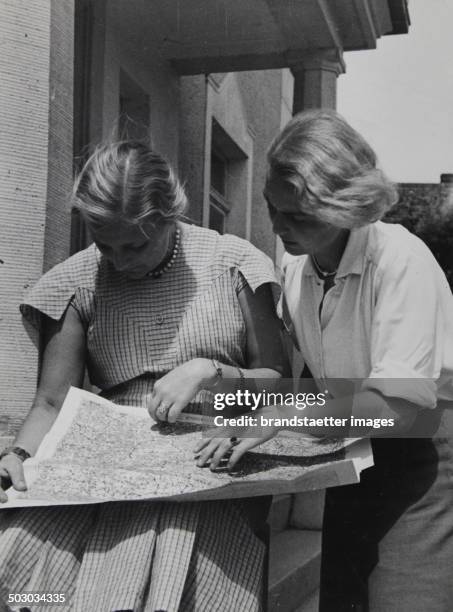 Two young women with a map, circa 1935. Photographie von Elisabeth Hase.