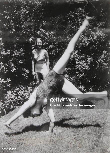 The American film actress Norma Shearer is doing cartwheels in her garden in Hollywood. She is being watched by her colleague Merle Oberon. 1936....