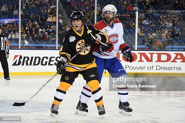 Rick Middleton of the Boston Bruins skates against Eric Desjardins of the Montreal Canadiens in the alumni game December 31, 2015 during 2016...