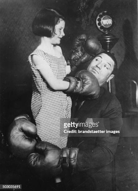 The boxer Jack Dempsey with the little Beverley MacPadden. About 1930. Photograph.