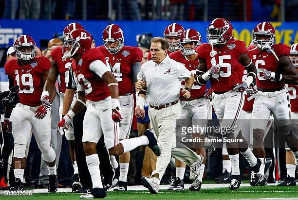Head coach Nick Saban of the Alabama Crimson Tide runs out of the tunnel with his team before taking on the Michigan State Spartans in the Goodyear...