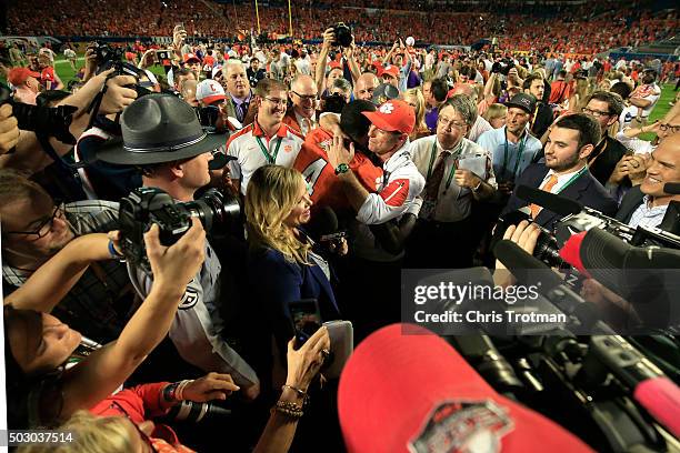 Head coach Dabo Swinney of the Clemson Tigers celebrates with Deshaun Watson after defeating the Oklahoma Sooners with a score of 37 to 17 to win the...