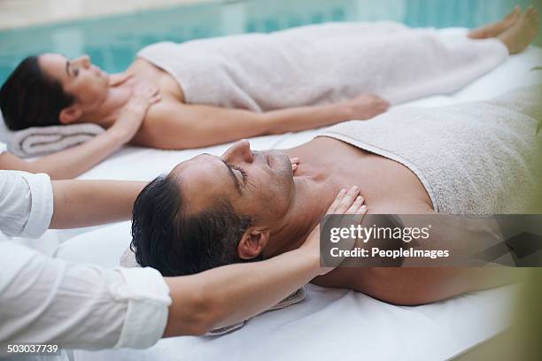 zen and comfort in synchronization - massage couple stock pictures, royalty-free photos & images