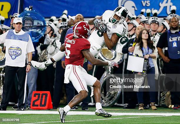 Wide receiver Aaron Burbridge of the Michigan State Spartans makes an 18-yard catch in the second quarter against Cyrus Jones of the Alabama Crimson...