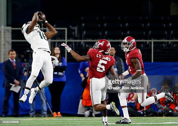 Wide receiver Aaron Burbridge of the Michigan State Spartans makes an 18-yard catch in the second quarter against Cyrus Jones of the Alabama Crimson...