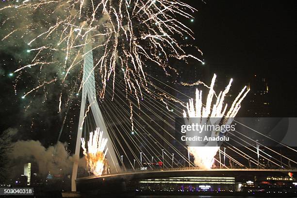 Fireworks and light shows illuminate the sky during New Year celebrations at Erasmusbrug in Rotterdam, Netherlands on January 01, 2016.