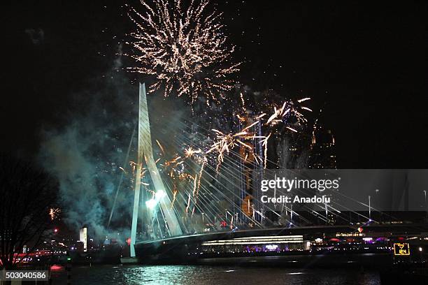 Fireworks and light shows illuminate the sky during New Year celebrations at Erasmusbrug in Rotterdam, Netherlands on January 01, 2016.