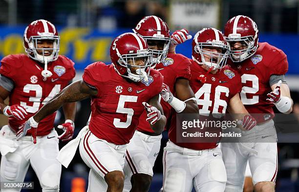 Cyrus Jones of the Alabama Crimson Tide celebrates with teammmates after returning a punt for a 55 yard touchdown in the third quarter against the...