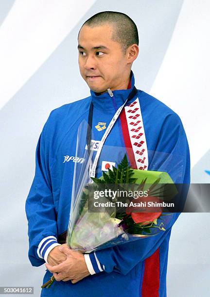 Bronze medalist Kosuke Kitajima of Japan bites his lip at the medal ceremony for the Men's 100m Breaststroke final during day two of the Pan Pacific...
