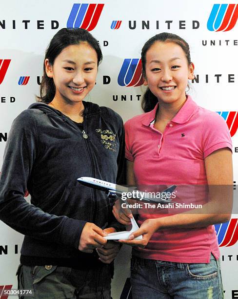 Figure skaters Mai Asada and younger sister Mao Asada pose for photographs during a press conference at Narita International Airport on August 28,...