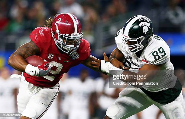 Running back Derrick Henry of the Alabama Crimson Tide stiff arms defensive end Shilique Calhoun and then runs for a touchdown in the fourth quarter...