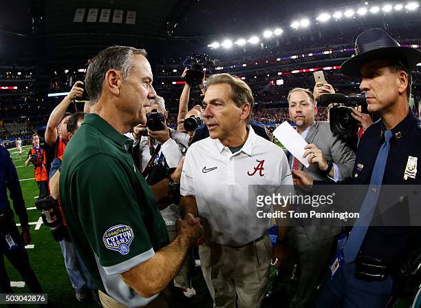 Head coach Nick Saban of the Alabama Crimson Tide shakes hands with head coach Mark Dantonio of the Michigan State Spartans after the Crimson Tide...
