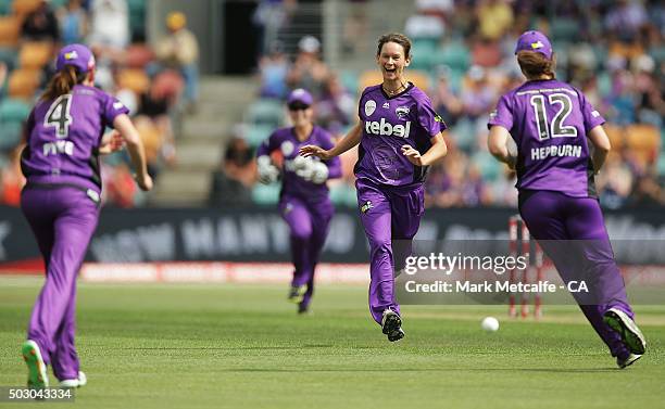 Veronica Pyke of the Hurricances celebrates with team mate Julie Hunter after taking a catch to dismiss Jessica Jonassen of the Heat during the...