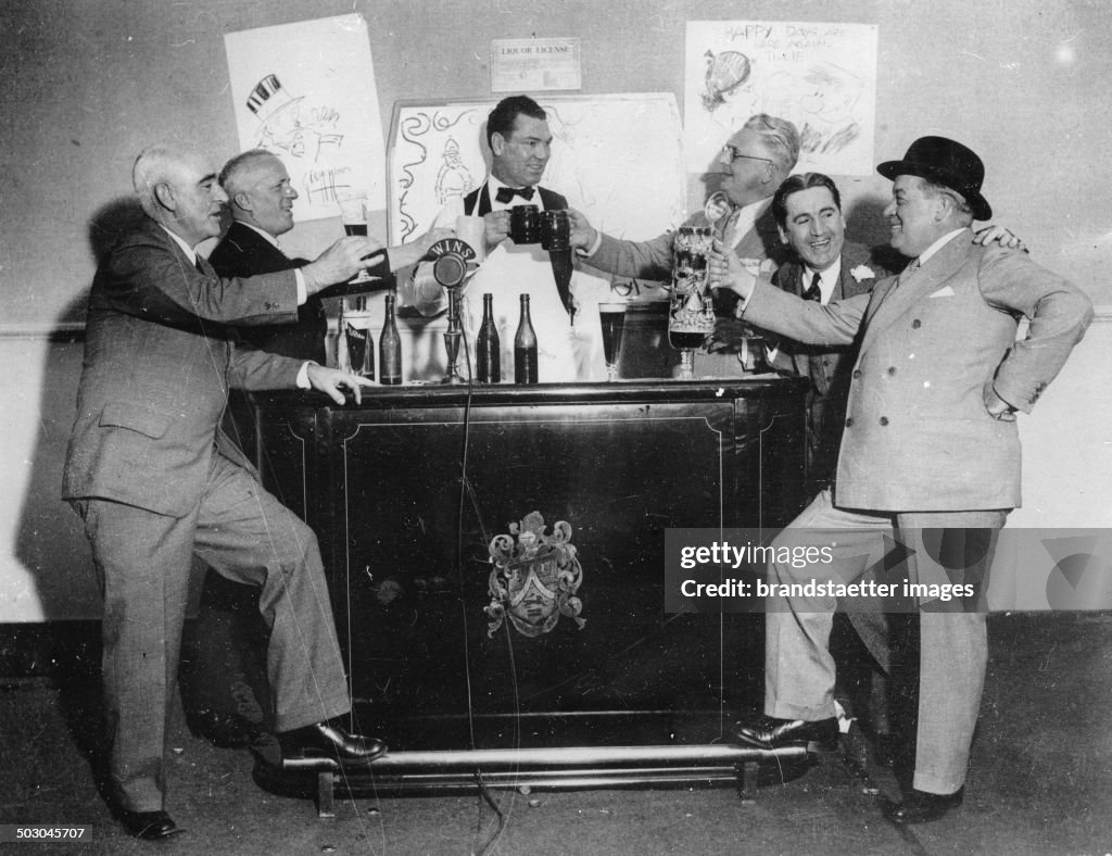 The Boxer Jack Dempsey (Center) At A Beer Party. From Left To Right Blue Burt Kenney - Arthur Baer - Jack Dempsey - Russ Westover - Freddie Steele - George Mcmanus. 14Th April 1933. Photograph.