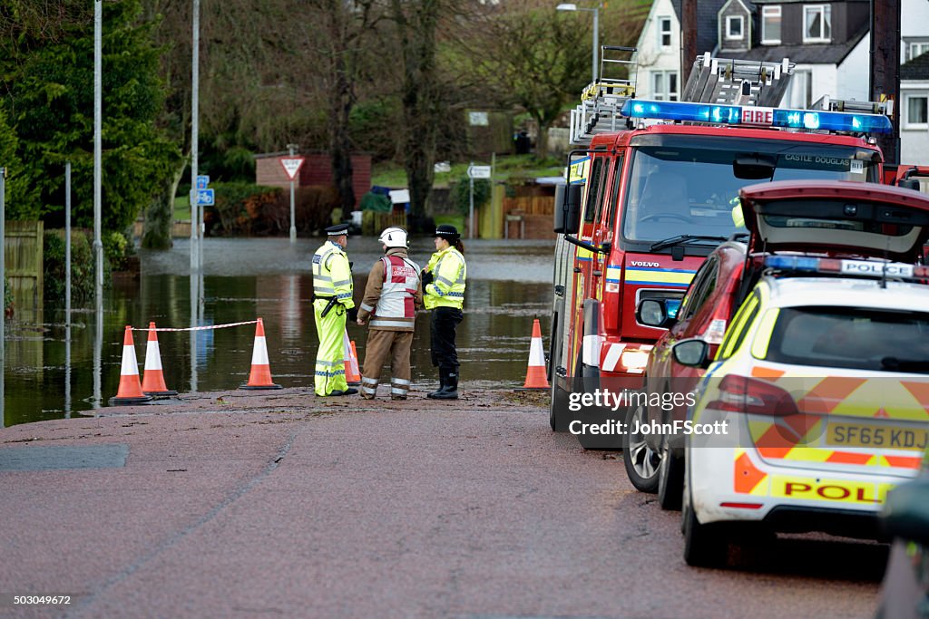 Scottish fire brigade personnel and police attending a flood