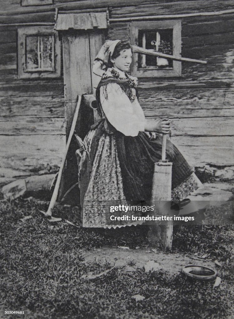 Silesian Peasant Girl In The Butter Stirring. Austrian Silesia. Poland. 1914. Photograph.