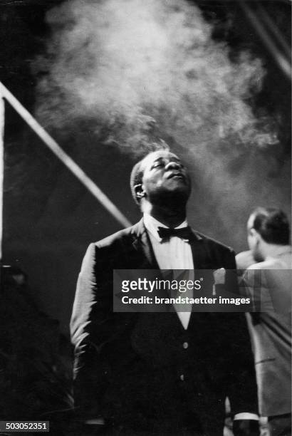 Louis Daniel Satchmo Armstrong smoking. Stadthalle. Vienna. 1959. Vienna. Photograph by Franz Hubmann.