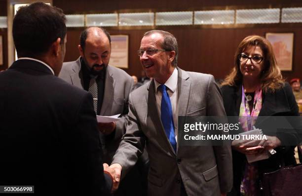 United Nations envoy to Libya, Martin Kobler shakes hands with members of Libya's General National Congress at the National Conference Hall in the...