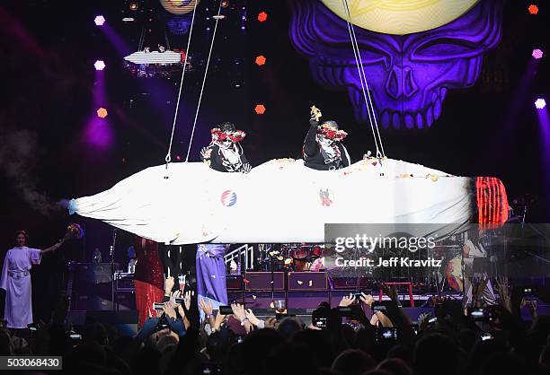 Trixie Garcia and Bernie Cahill ride a joint during the Dead and Company performance at The Forum on December 31, 2015 in Inglewood, California.