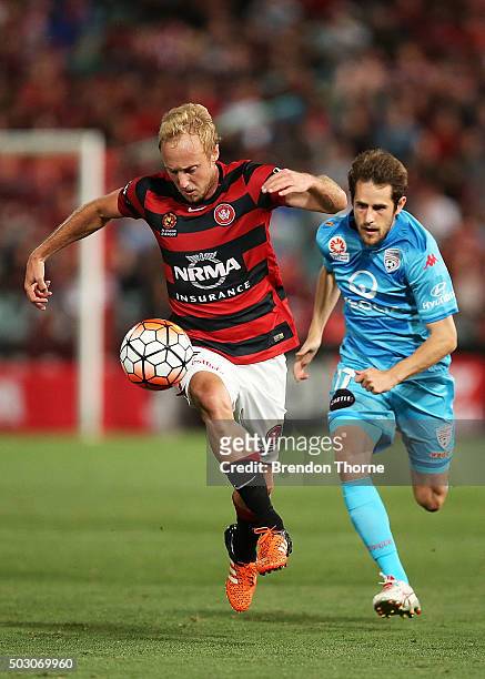 Mitch Nichols of the Wandererscompetes with Mate Dugandzic of Adelaide during the round 13 A-League match between the Western Sydney Wanderers and...