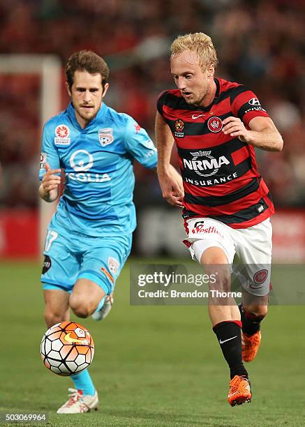 Mitch Nichols of the Wandererscompetes with Mate Dugandzic of Adelaide during the round 13 A-League match between the Western Sydney Wanderers and...