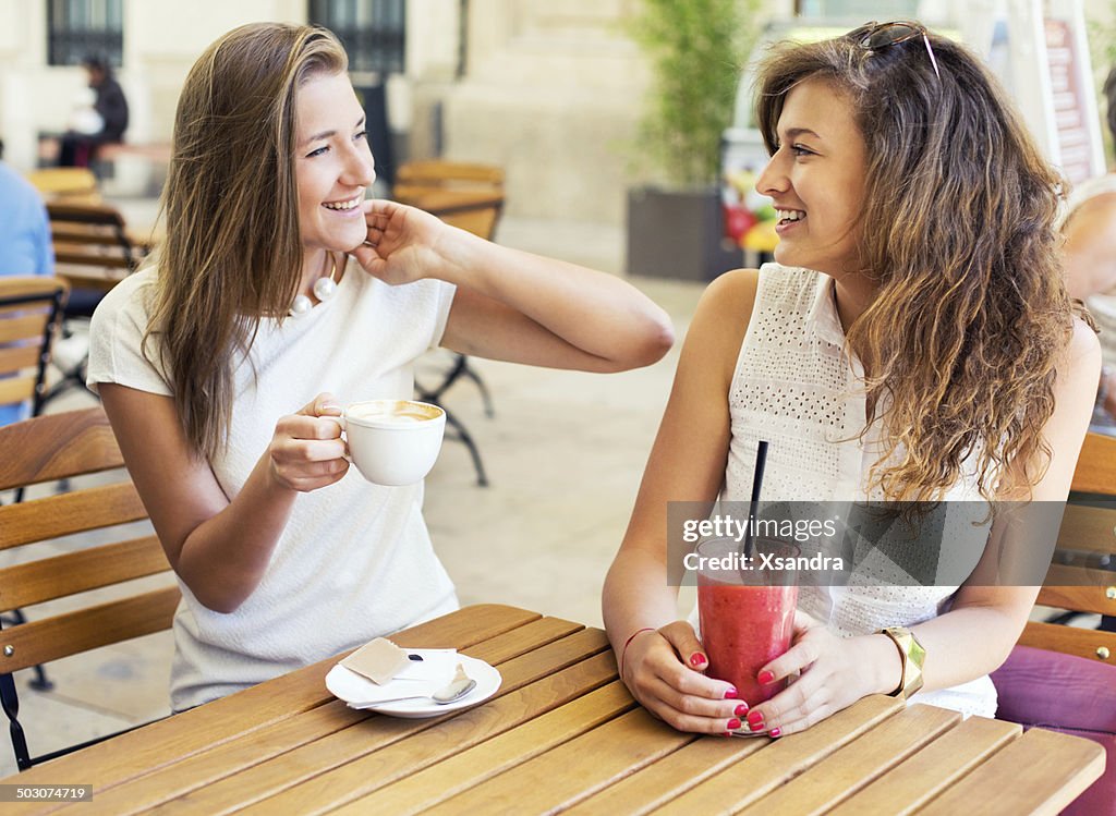 Two Young Women Sitting in Cafe