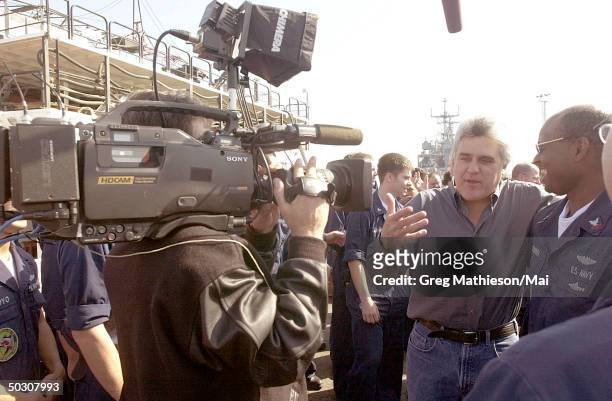 Television personality Jay Leno greeting sailors on a dock in support of Operation Enduring Freedom.