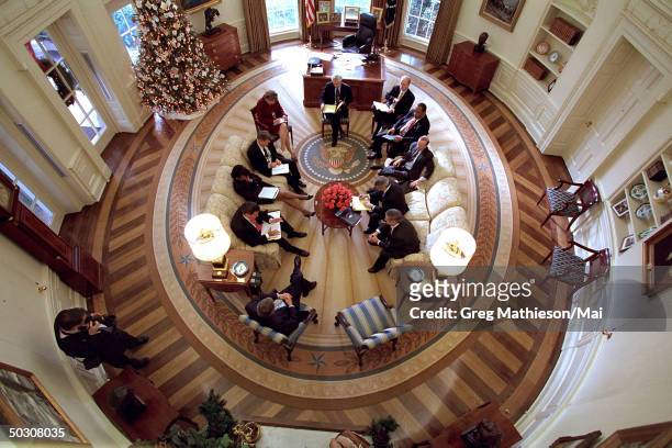 President George W. Bush hosting meeting in Oval Office of White House decorated w. New presidential rug. The rug, which is unique to the Bush...