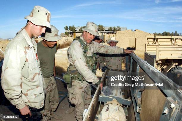 Chief Machinist Mate Jon Scott, assigned to Explosive Ordnance Disposal , Mobile Unit Two, Detachment-18 instructs Sailors and Marines on procedures...