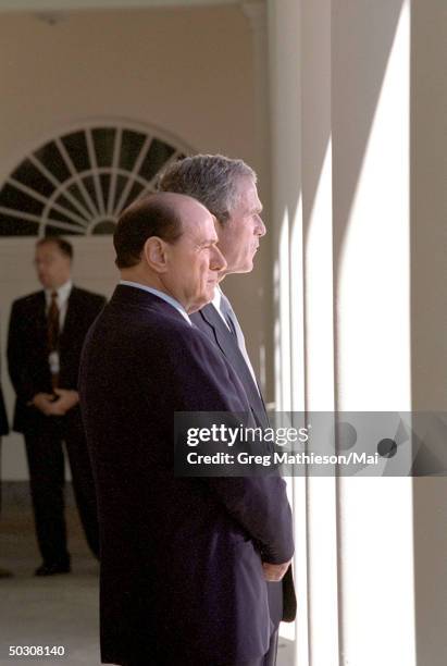 Visiting Italian Prime Minister Silvo Berlusconi and US Pres. George W. Bush waiting to make a joint statement to the media from the White House.