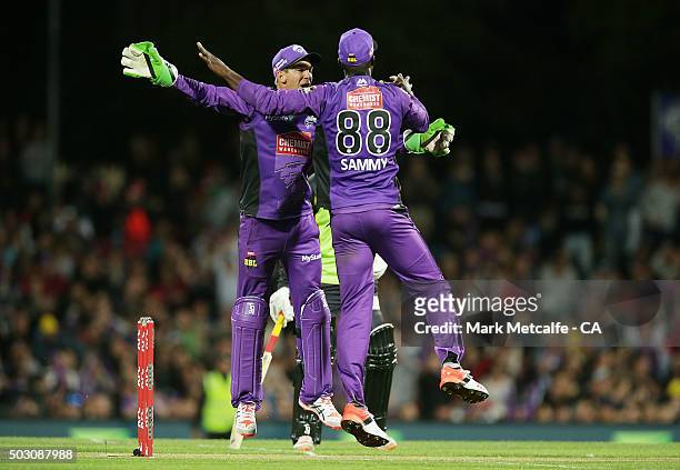 Tim Paine and Darren Sammy of the Hurricanes celebrate victory in the Big Bash League match between the Hobart Hurricanes and the Sydney Thunder at...