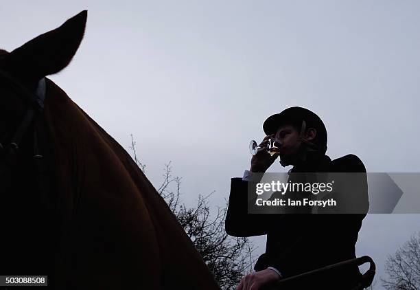 Rider drinks a Whisky as the tradition drinks are passed around as horses, riders and hounds from the Cleveland Hunt prepare to ride out on the...