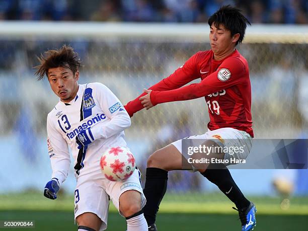 Hiroyuki Abe of Gamba Osaka and Yuki Muto of Urawa Red Diamonds#20 compete for the ball during the 95th Emperor's Cup final between Urawa Red...