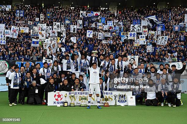 Players of Gamba Osaka celebrate with fans as Yasuhito Endo lifts the trophy after the 95th Emperor's Cup final between Urawa Red Diamonds and Gamba...